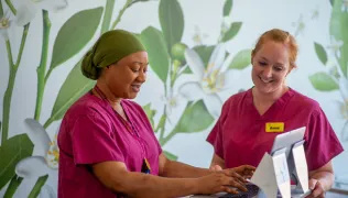 2 midwives looking at computer