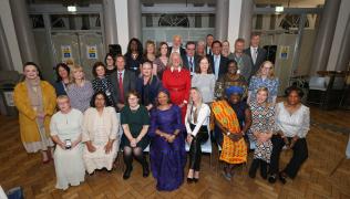 Large group photo of the 30 recipients of the Long Service Awards. All sitting and standing in Shepherd Hall at St Thomas' Hospital