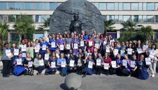 A group of nurses and midwives with certificates at the Mary Seacole Memorial Statute