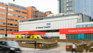 Photo of emergency department (A&E) at St Thomas' Hospital with ambulances in bay, from across the road