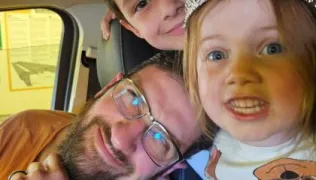 The Holman family take a selfie, with Alana in the front next to Clint and brother Caleb behind them. 