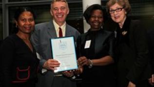 Staff receieve award from Dame Carol Black
