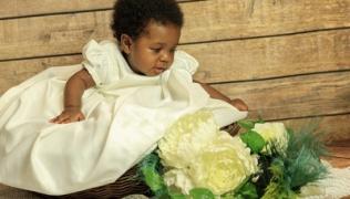 Baby Gail Shennan in basket next to white flowers for web