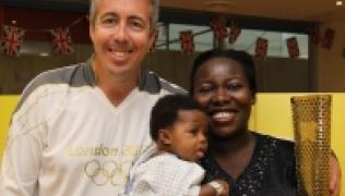 Torch bearer, Kevin Craig (left) and Evelina patient with mother