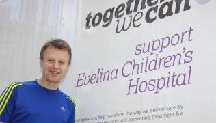 David Dean standing next to a 'support Evelina Children's Hospital sign