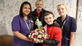 Jonjo Heuerman and his mum hand over flowers to nurses at Guy's Hospital