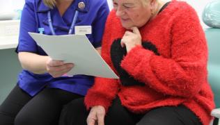 a nurse explaining the friends and family test to a patient