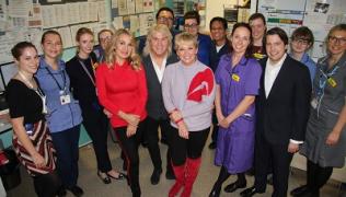 Bucks Fizz members pose with staff during visit to Guy's