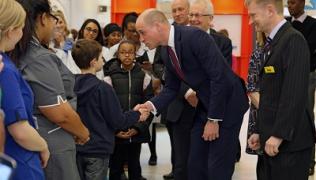Duke of Cambridge shakes boy's hand during visit to Evelina London