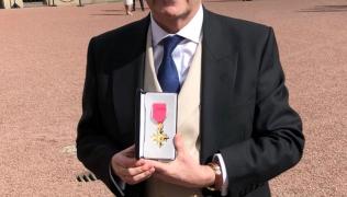 Professor Andrew Shennan with his OBE at Buckingham Palace
