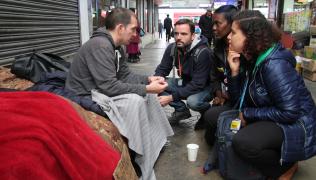 Nurses Kendra Schneller, Serina Aboim, Graeme Seccombe talk to a homeless man