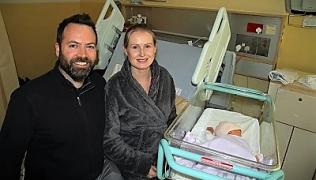 Man and woman with their baby born on New Year's Day