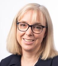 Dr Anne Rigg, consultant medical oncologist. Woman with shoulder length blonde hair and glasses.