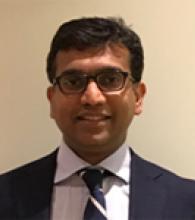 Vinod Mullassery is a man with short black hair and glasses