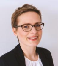 Deborah Enting is a woman with short brown hair and glasses