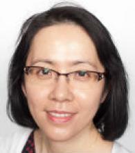 Cynthia Yu-Wai-Man is a woman with chin length black hair and glasses