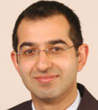 Moin Mohamed is a man with very short black hair and glasses