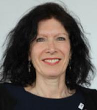Beverley Hunt is a woman with shoulder length black wavy hair