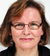 Marlies Ostermann is a woman with chin length brown hair and glasses