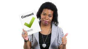 A woman holds up a form with a green tick and the word 'consent' on the cover. She is smiling and giving a thumbs-up