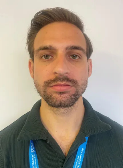 Photo of a man in an upright posture with his mouth closed and the jaw relaxed.