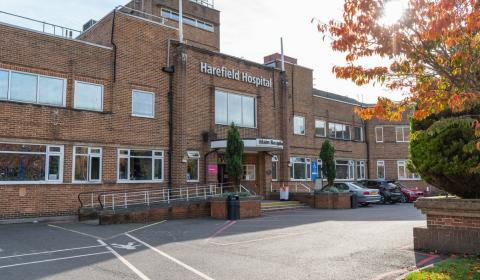 Outside view of Harefield Hospital. Brick building with a ramp leading up to the main reception entrance.