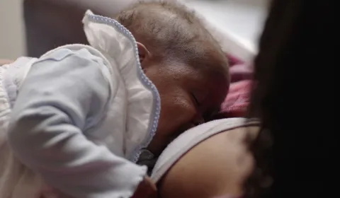 Close-up of a 2-month-old baby breastfeeding