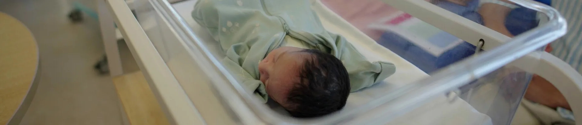 Close-up of a newborn baby during a breastfeeding class on the postnatal ward.