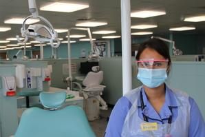 Dental nurse Sharanpreet Bumbra wearing a face mask and eye protection at Guy's Hospital.
