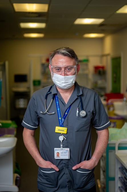 Clinical nurse specialist, wearing a dark grey uniform and working in the Acute Oncology Service (AOS) in the Cancer Centre at Guy's. 