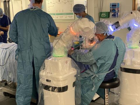 Surgeons operate on a patient with the Versius robot