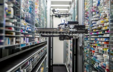 	Close up of pharmacy dispensing robot withcoloured boxes of medication on shelves