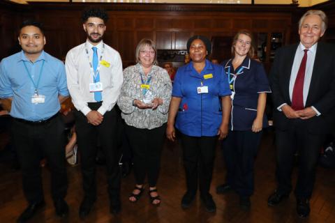Photo shows the Ophthalmology outpatients team with Charles Alexander at the CARE awards