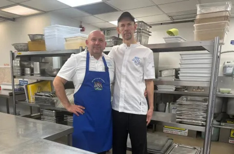 Chef Ned and Scott in chef whites, standing in St Thomas' kitchen.