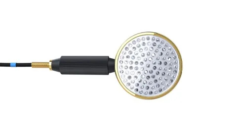 A probe with a round, gold head that has lots of small LED lights in it. It has a black handle and is connected to a cable. It looks like a shower head.