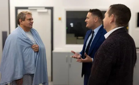 Secretary of State for Health and Social Care Wes Streeting speaking with Royal Brompton lung surgery patient Mark Dunham 
