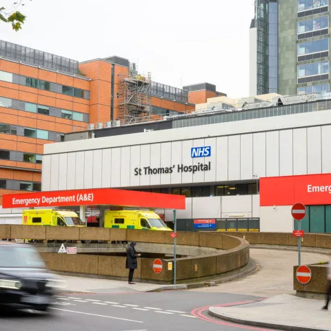 Photo of emergency department (A&E) at St Thomas' Hospital with ambulances in bay, from across the road