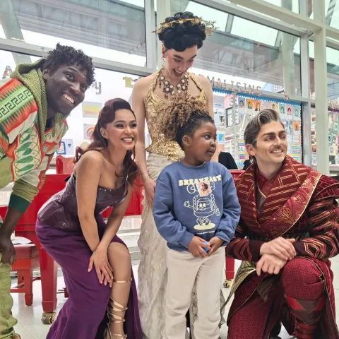 A young Evelina London patient with four Hercules cast members in costume