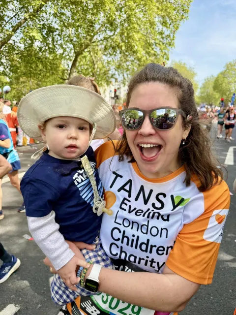 Evelina London runner, Tansy Simpson, holding her son Atlas after finishing the race. 