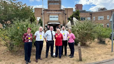 Members of staff, including catering team, standing with Tim Radcliffe outside Harefield Hospital