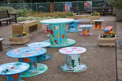 Our pop up garden, created with decoratively painted cable reels