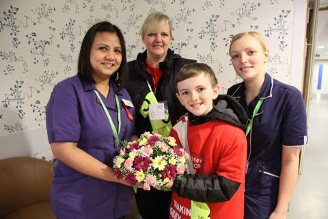 Jonjo Heuerman and his mum hand over flowers to nurses at Guy's Hospital
