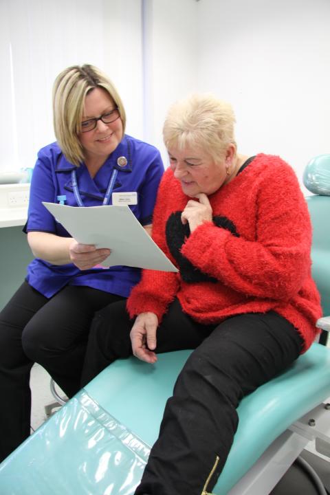 a nurse explaining the friends and family test to a patient