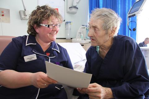 Staff Nurse Karen Jackson talks with patient Alan Short
