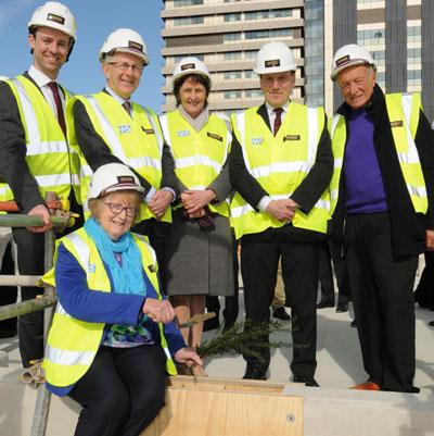 Breast cancer survivor Diana Crawshaw carries out the traditional 'topping out' of the new Cancer Centre at Guy's