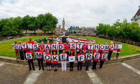 Our smoke-free champions hold up cards reading Guy's and St Thomas' smoke-free 