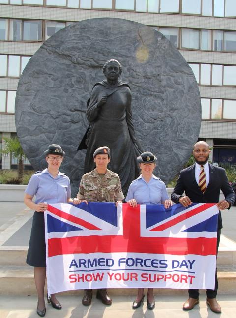 4 people holding a GB flag with the message 'Armed forces day - show you support' 