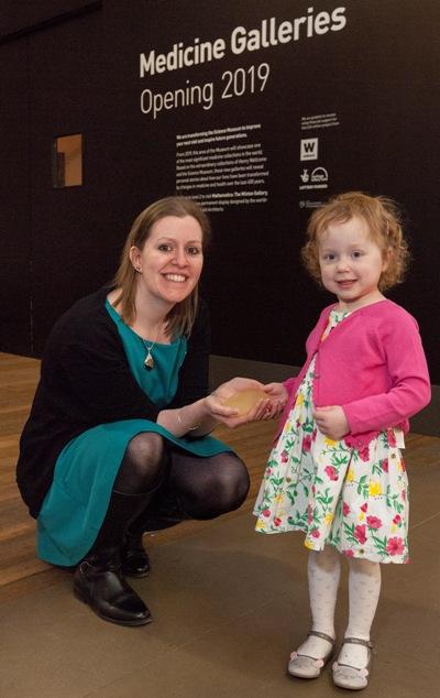 Lucy Boucher hands over the 3D model of her father's kidney to Selina Hurley from the Science Museum