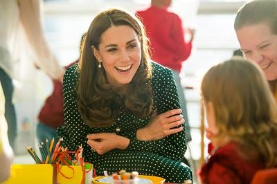 Duchess of Cambridge talking to a child while visiting Evelina London