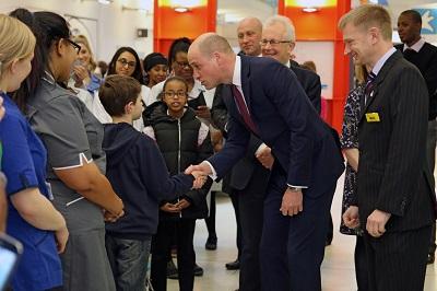 Duke of Cambridge shakes boy's hand during visit to Evelina London